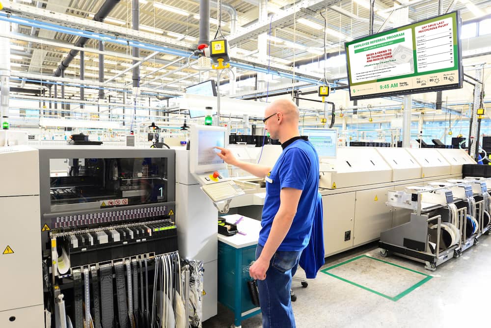 A manufacture employee working on the machine.